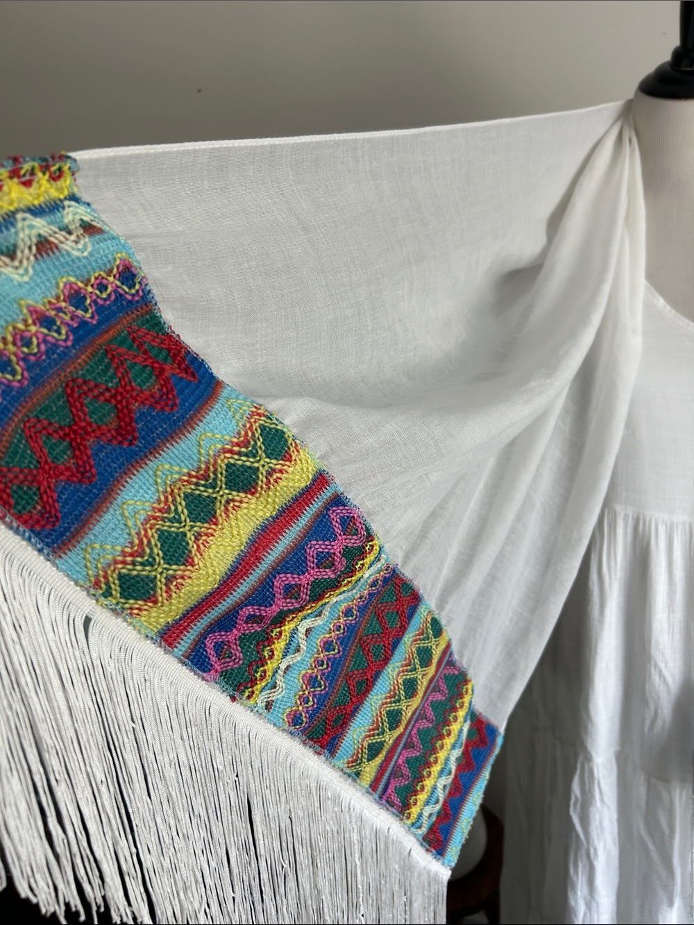 World Market white fringe scarf with red blue yellow green stitching